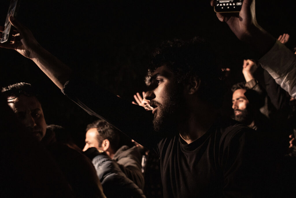 Night after the attack, a checkpoint set up 15 km from Pahalgam to stop anyone fromreaching the town, as a crowd gathers to protest the massacre. 